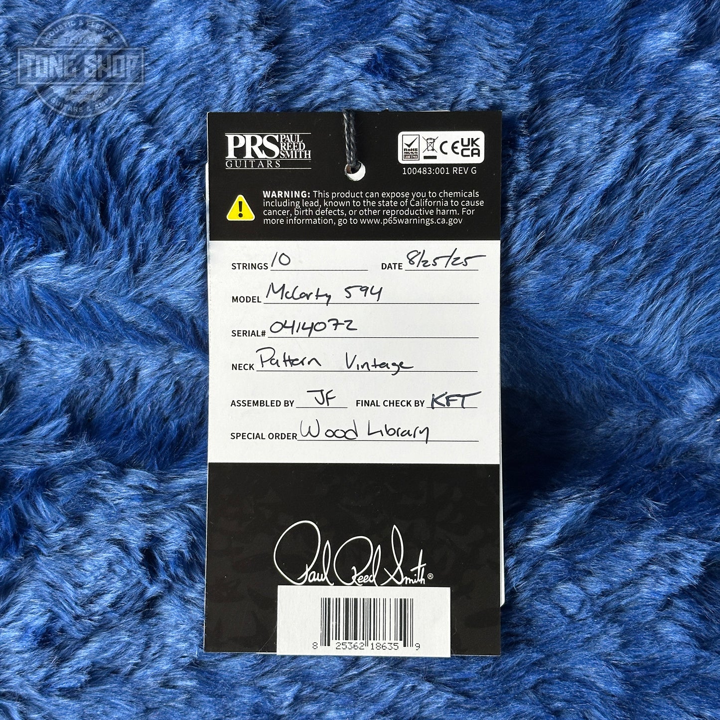 PRS guitar strings packaging with product details on a blue textured background