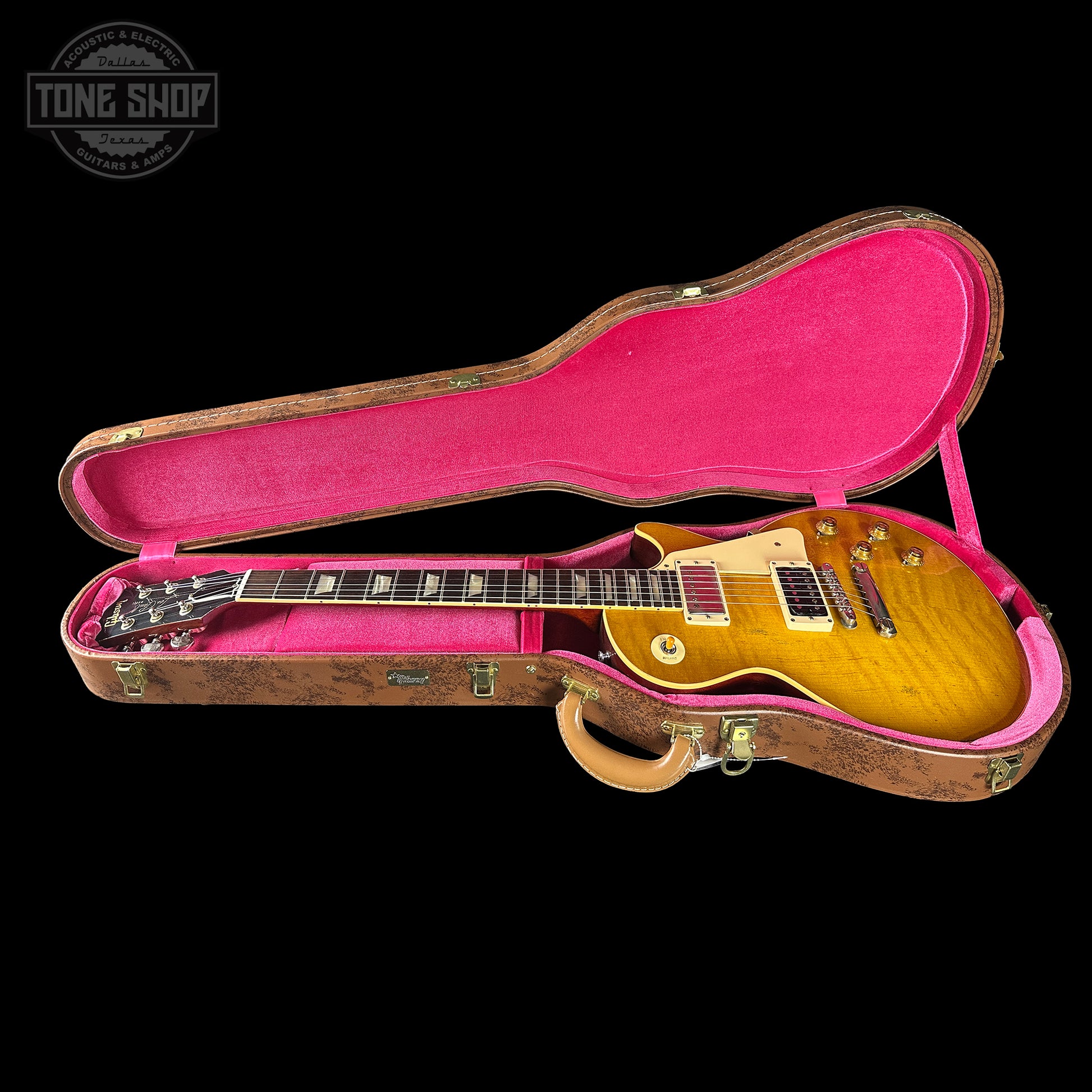 Gibson Les Paul guitar in a pink-lined case with 'Tone Shop' logo.