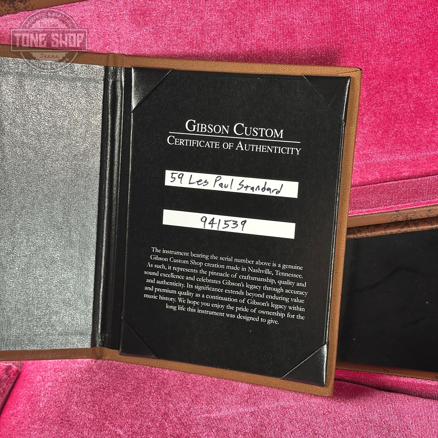 Gibson Custom Certificate of Authenticity on a pink surface