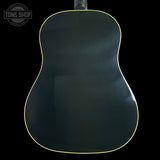 The back of a glossy acoustic guitar with a dark green finish and a thin gold edge trim, shown against a solid black background.