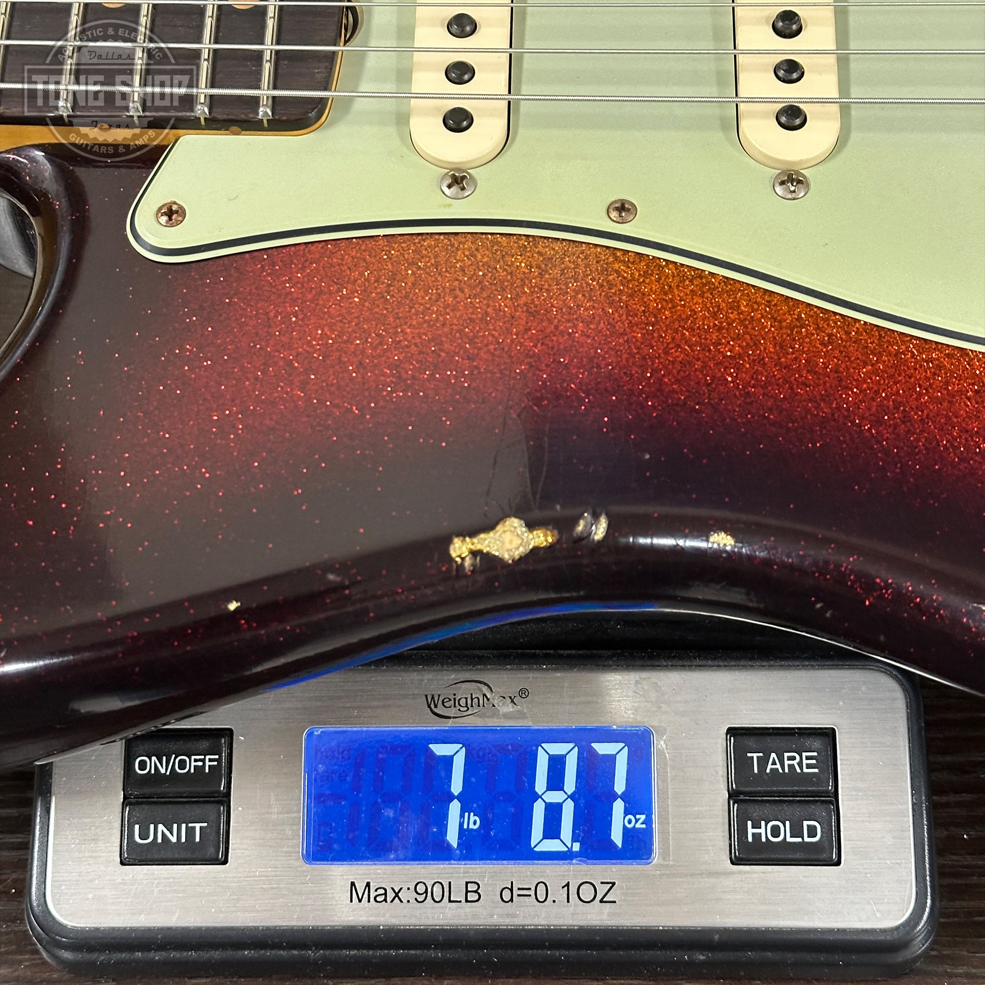 Guitar on a digital scale displaying weight