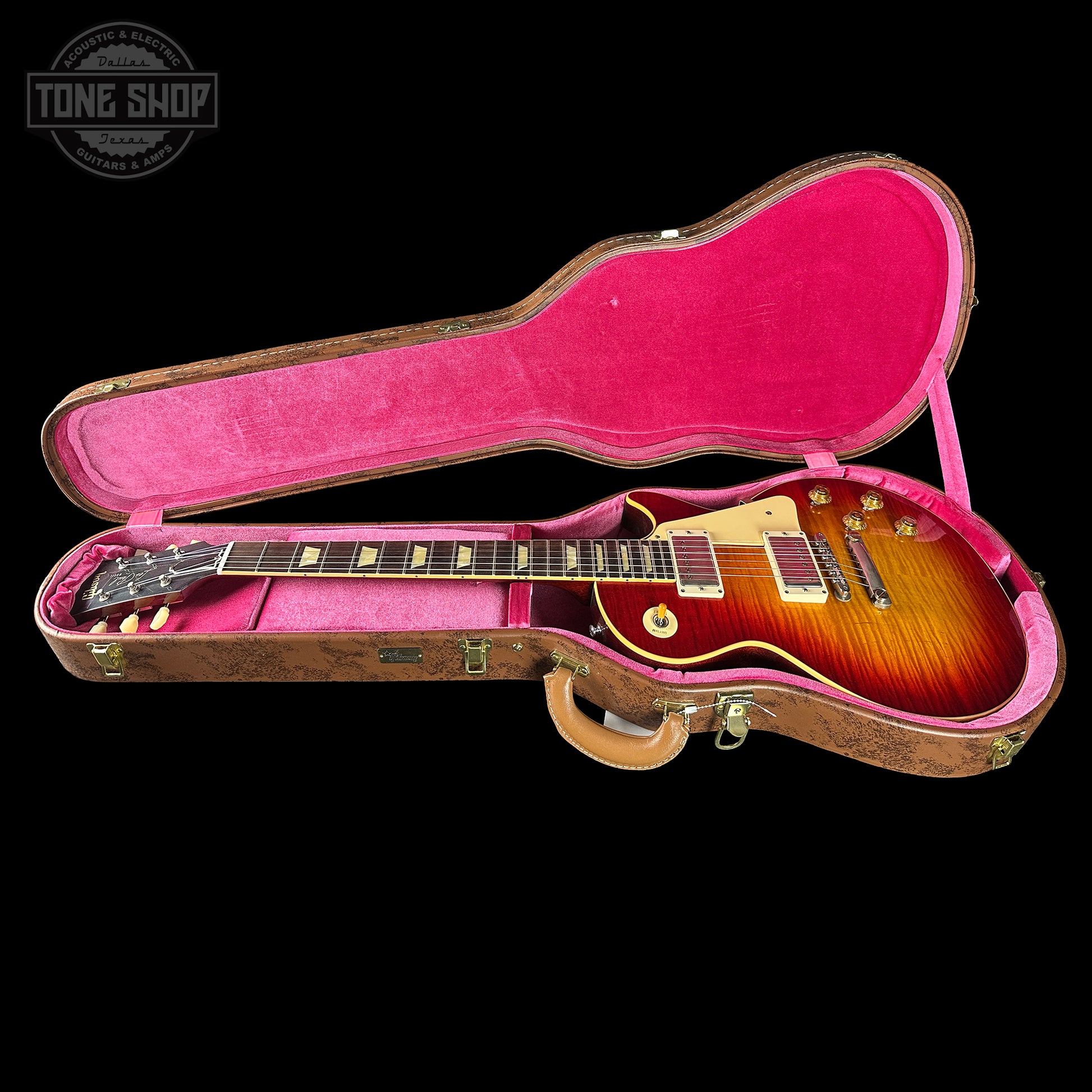 Gibson Les Paul guitar in a pink case with 'Tone Shop' logo.