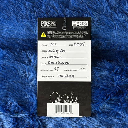 PRS guitar label on a blue textured background