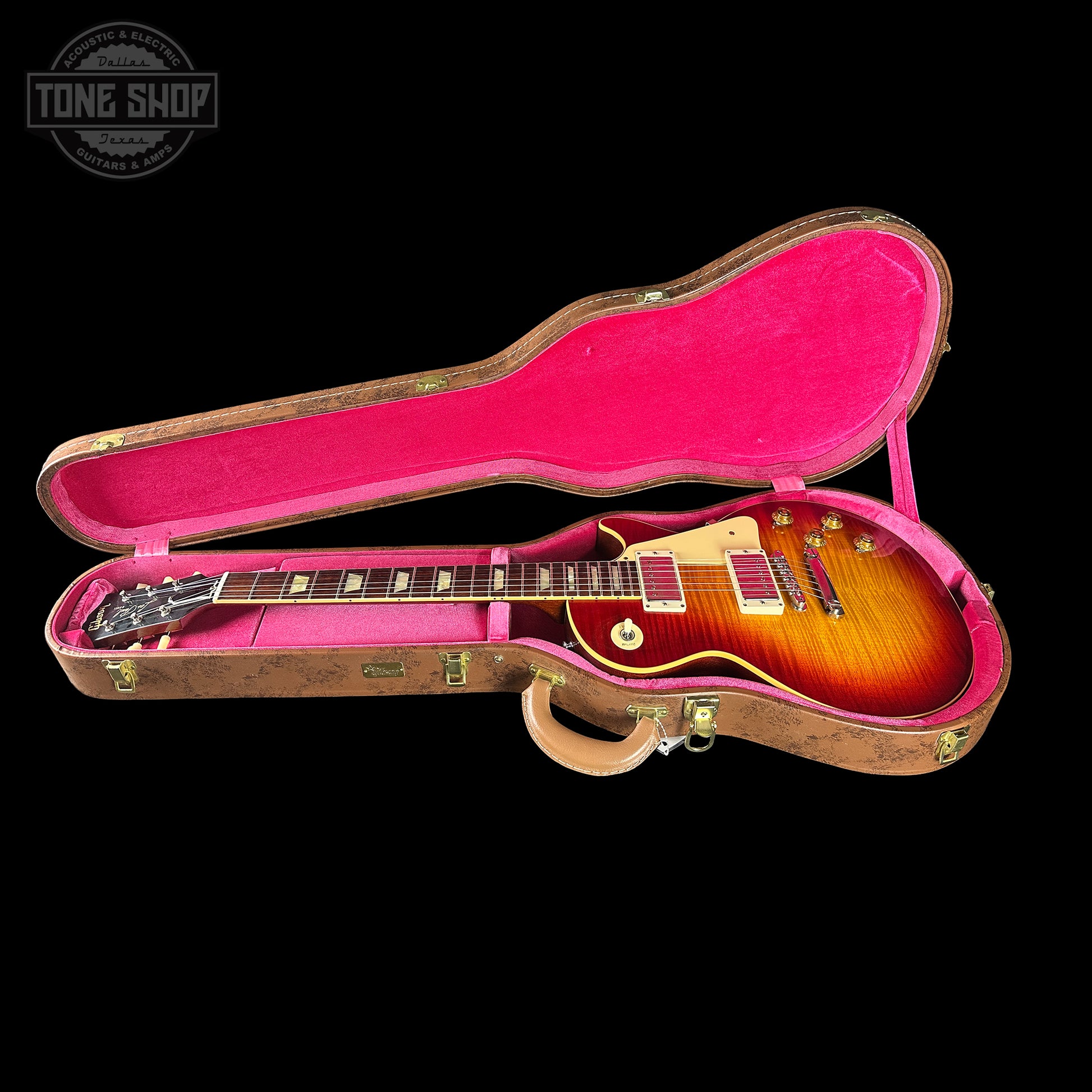 Gibson Les Paul guitar in a pink case with 'Tone Shop' logo.