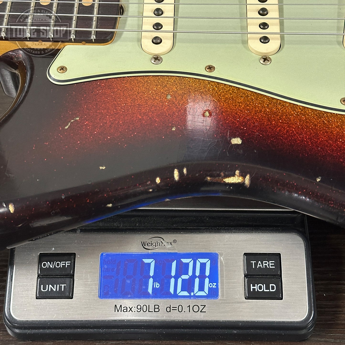 Guitar on a digital scale displaying weight