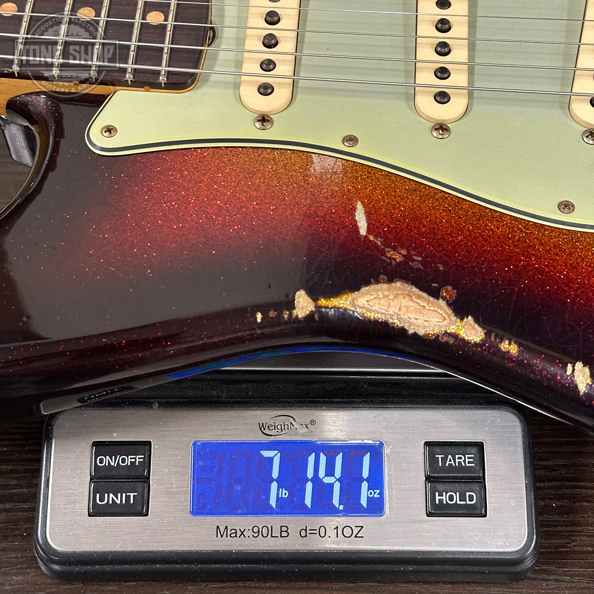 Guitar on a digital scale displaying weight