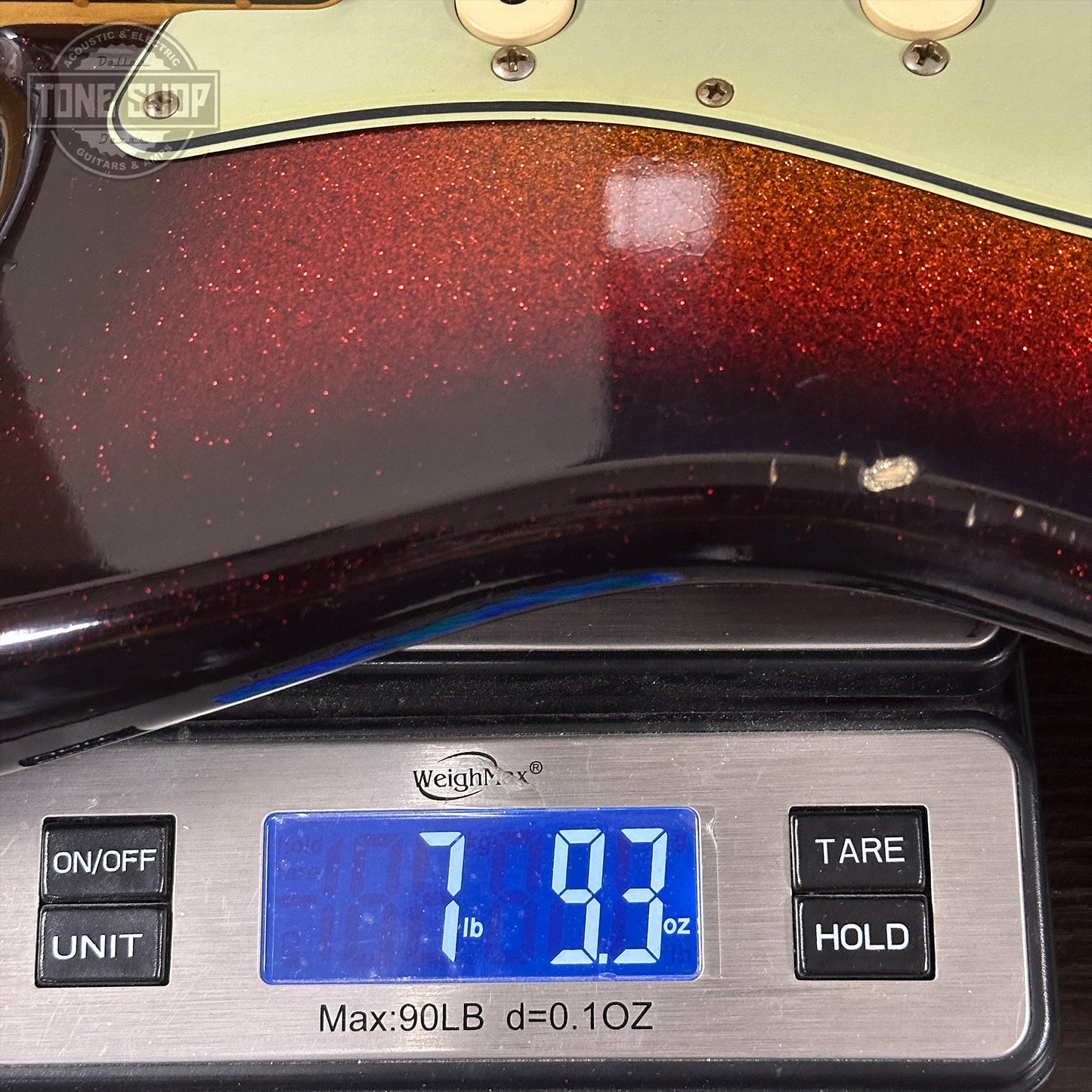 Guitar body on a digital scale displaying weight