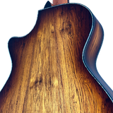 Close-up of a wooden guitar body with a white background
