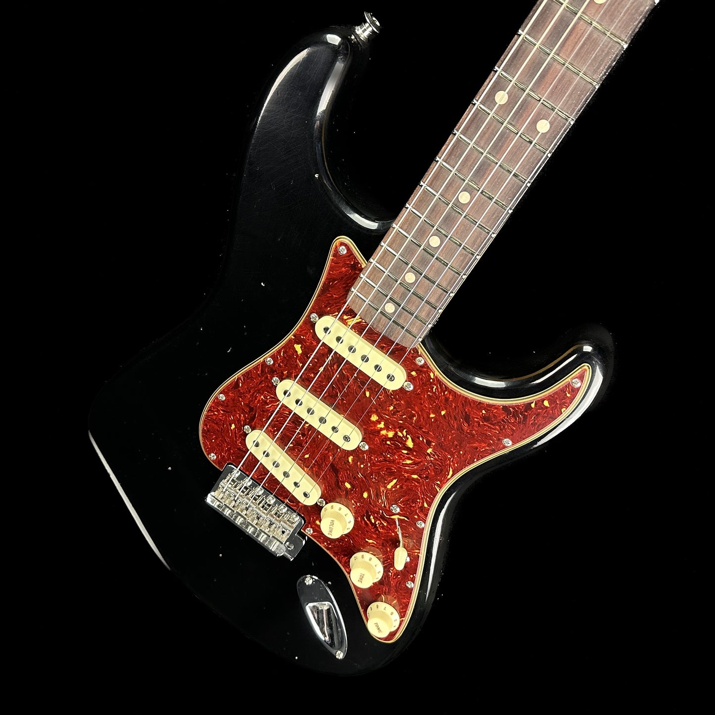 Front angle of Fender Custom Shop Postmodern Strat RW Journeyman Relic w/Closet Classic Hardware Aged Black.