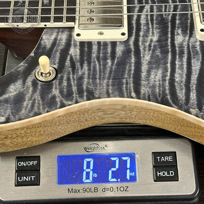 Guitar on a digital scale displaying weight
