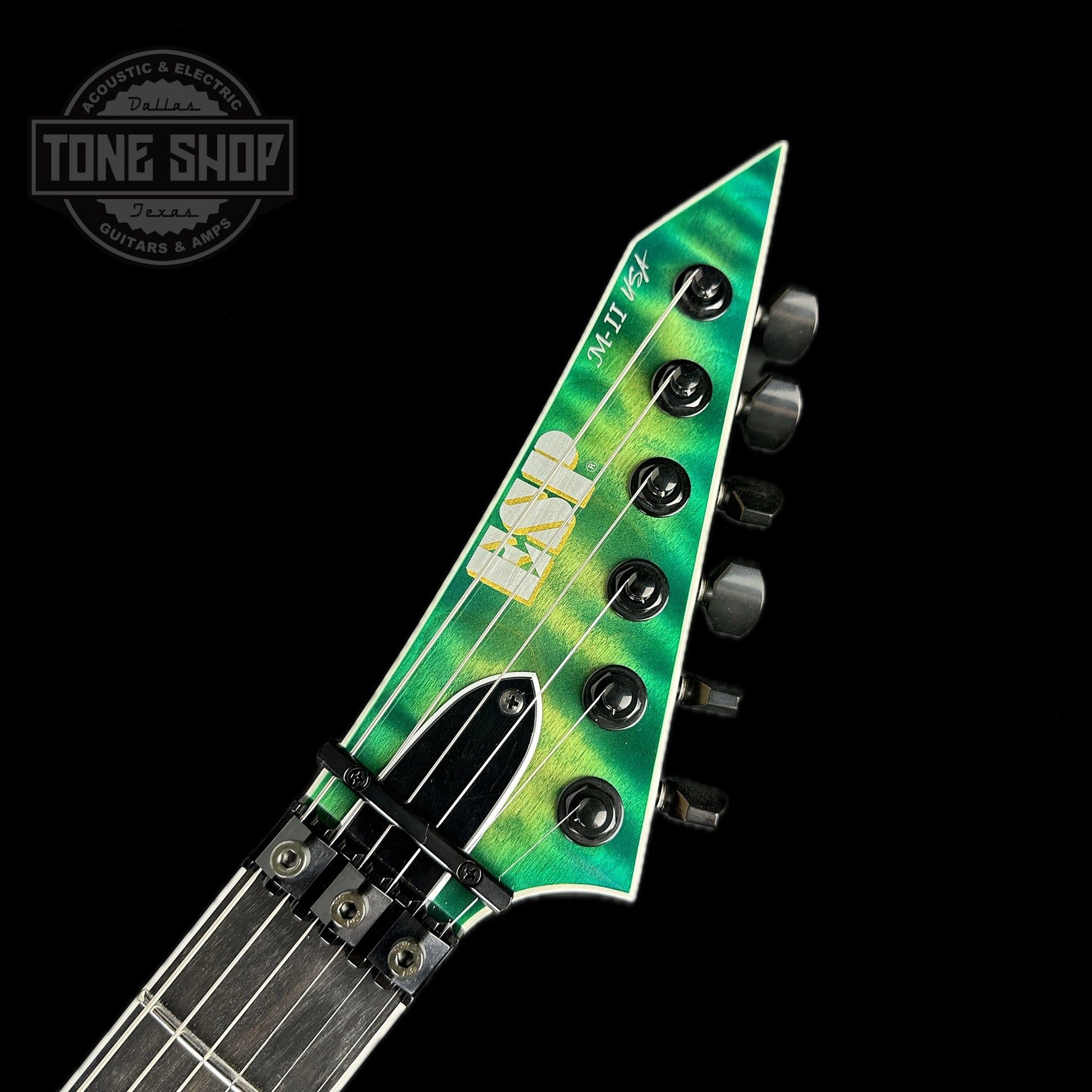 Front of headstock of ESP USA M-IIDX FR Floyd Rose Quilted Maple Lime Burst.