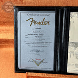 Fender certificate of authenticity in a black holder on a wooden surface