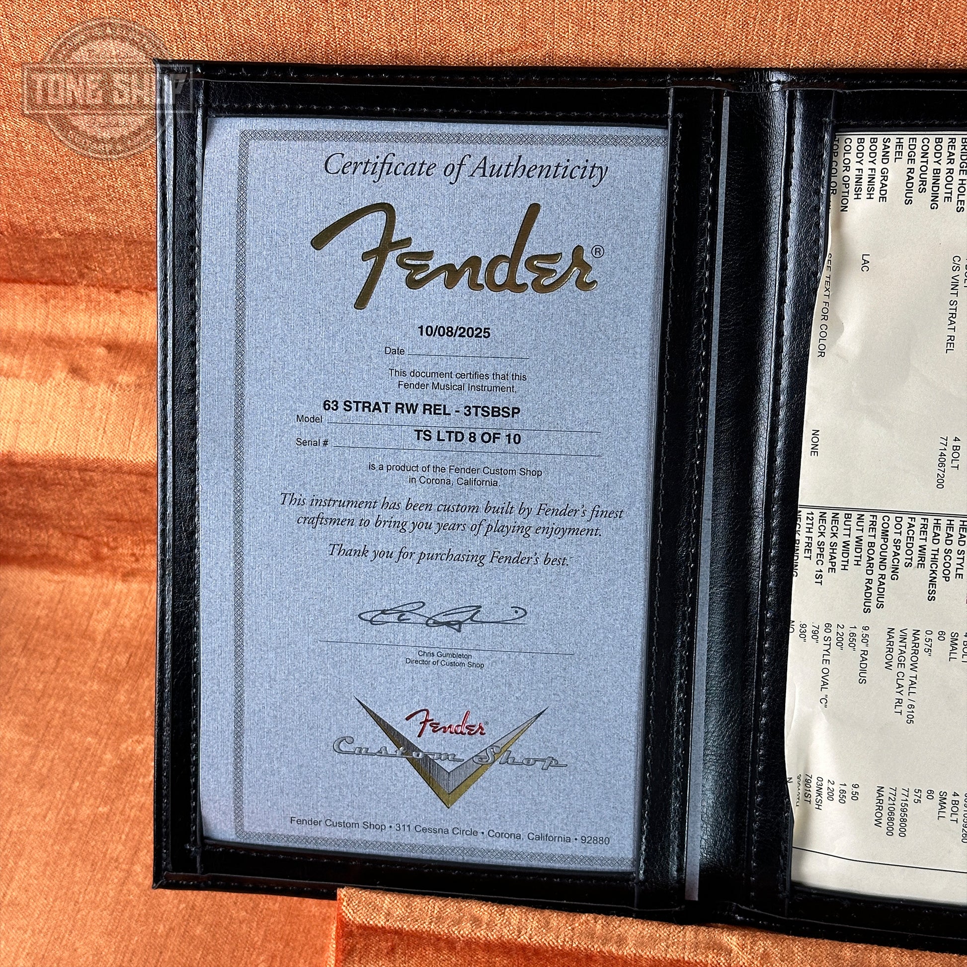 Fender certificate of authenticity in a black frame on an orange background