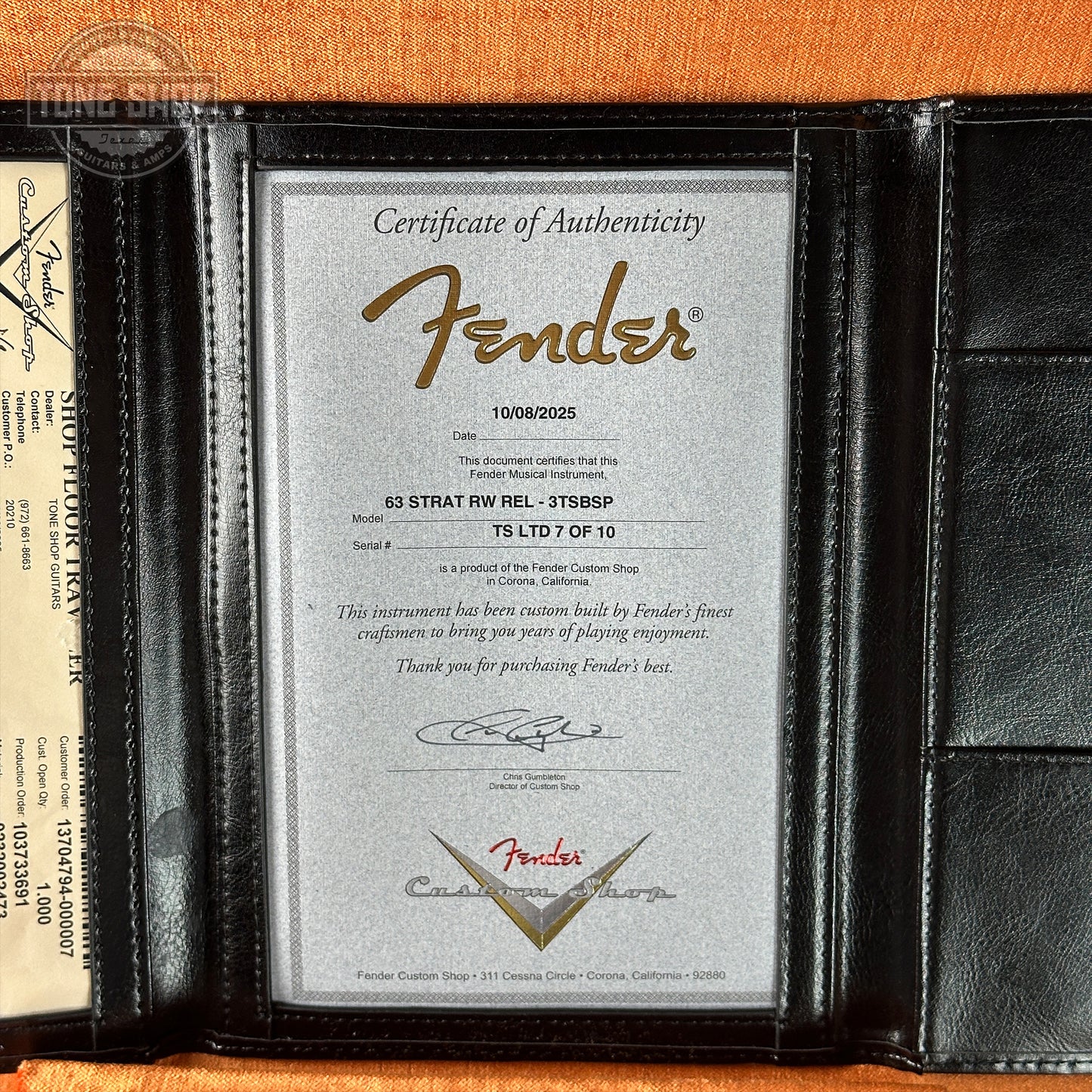 Fender certificate of authenticity in a black frame on an orange background