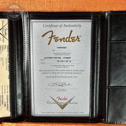 Fender certificate of authenticity in a black frame on an orange background