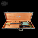 Guitar in an open case with a visible brand logo on a black background