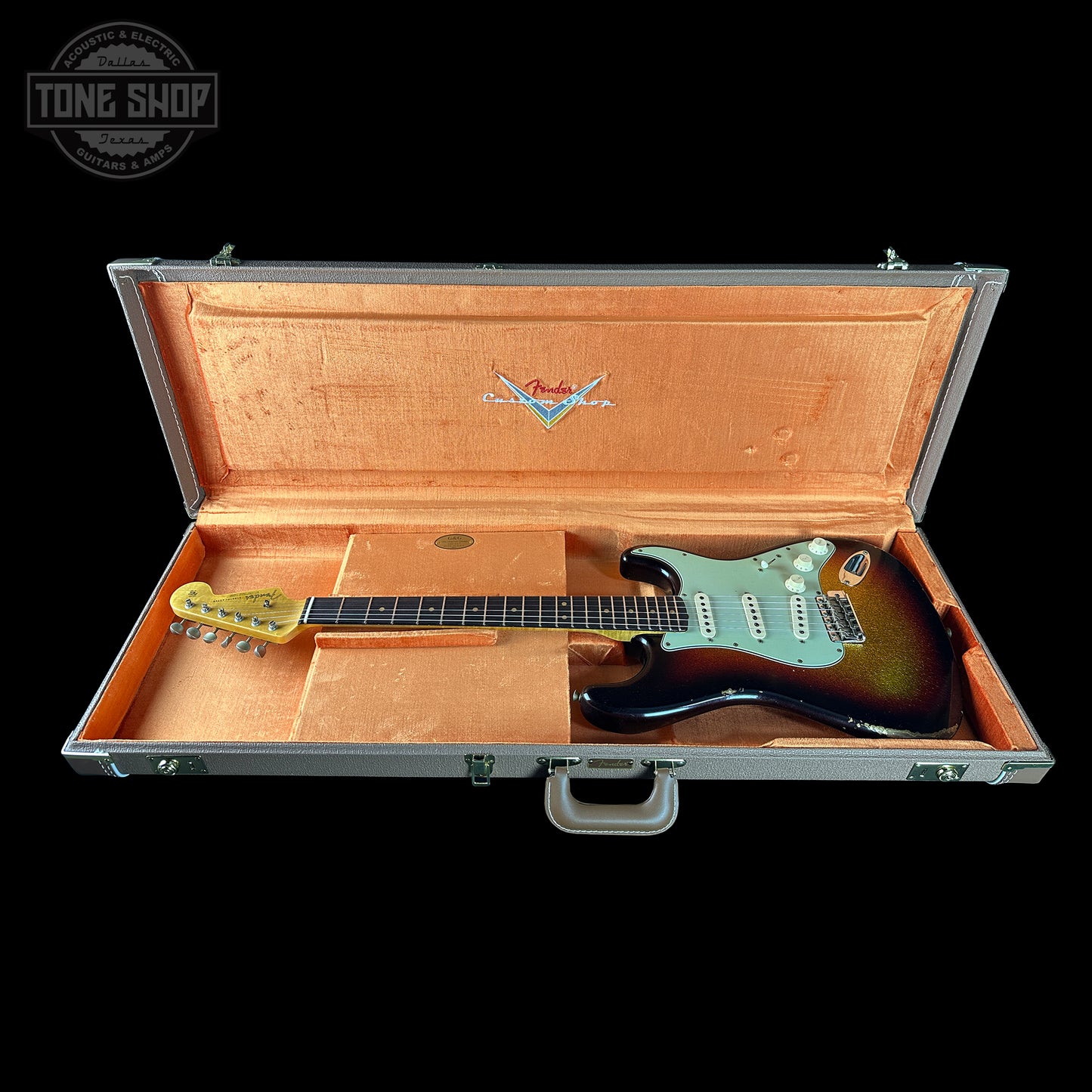 Fender electric guitar in an open case with Fender logo.