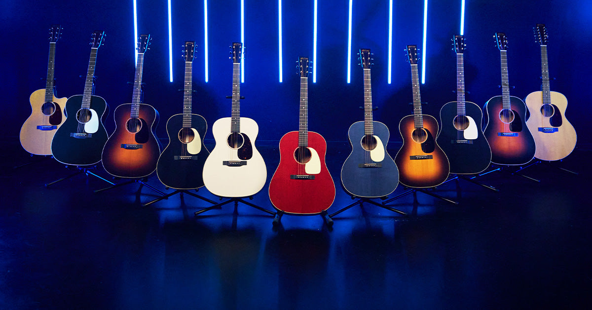 A group of Martin acoustic guitars in various finishes on stands against a black background with blue lights, with "the all new 16 series above them in white font.