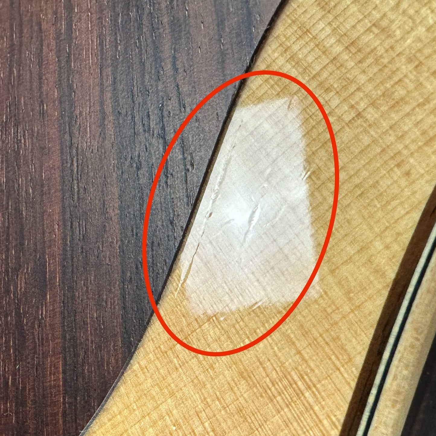 Scratches near pickguard of Used 2019 Taylor 814ce Natural.