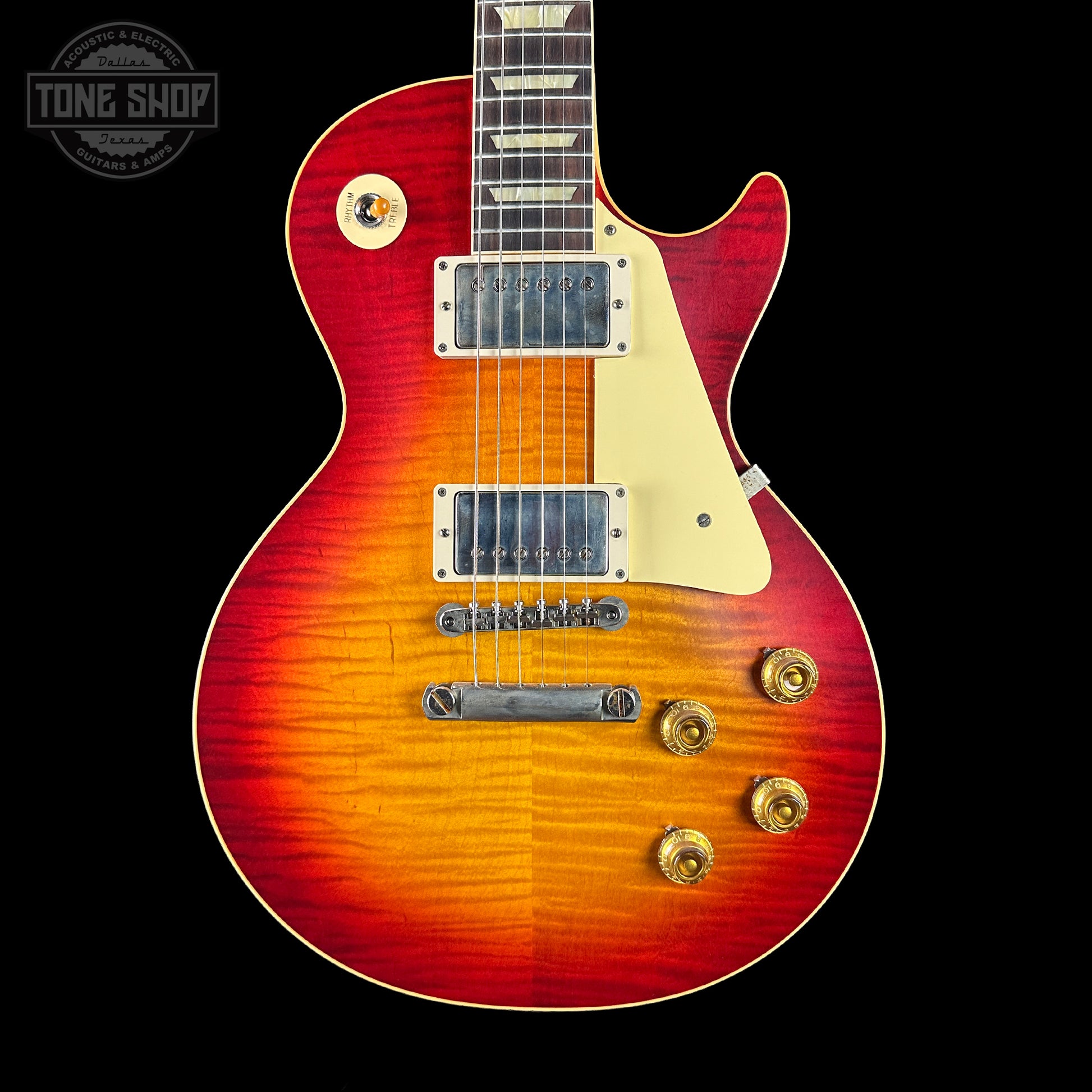 Electric guitar with a sunburst finish on a black background, featuring the Tone Shop logo.