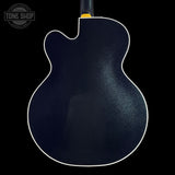 Black electric guitar body on a black background with 'Tone Shop' logo.