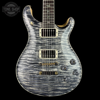 Electric guitar with a unique pattern on the body against a black background, featuring the Tone Shop logo.