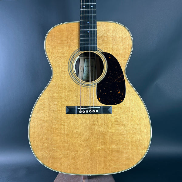 Acoustic guitar with a wooden finish on a dark blue background