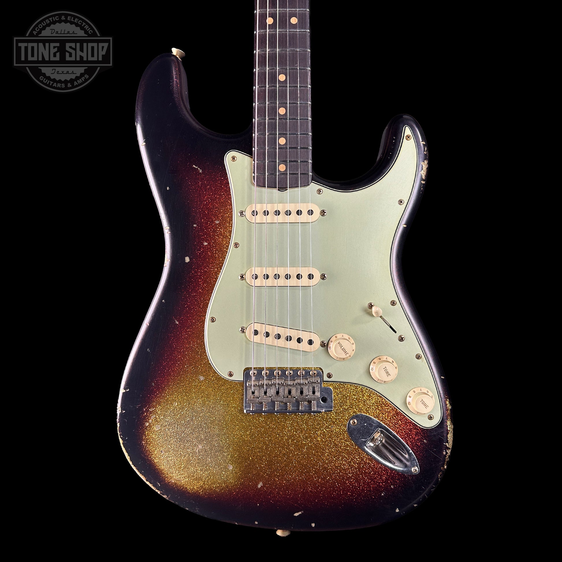 Electric guitar with a sunburst finish on a black background, featuring the Tone Shop logo.