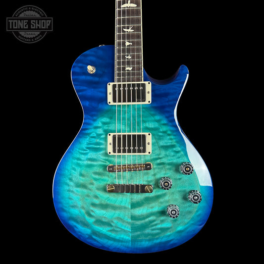 Blue electric guitar with a gradient finish on a black background, featuring the Tone Shop logo.