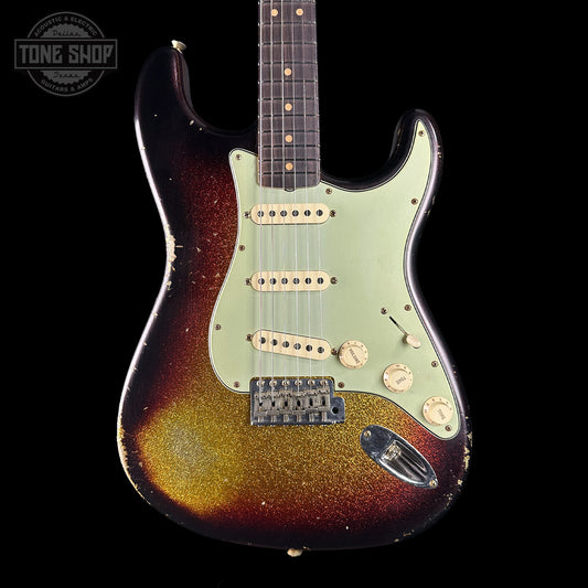 Fender Stratocaster guitar with sunburst finish on a black background