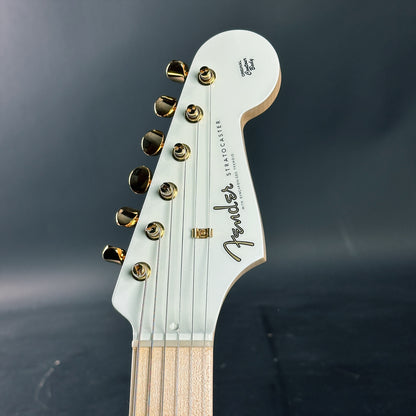 Close-up of a Fender Stratocaster guitar headstock on a dark background