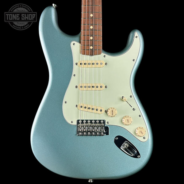 Electric guitar with a light blue finish on a black background