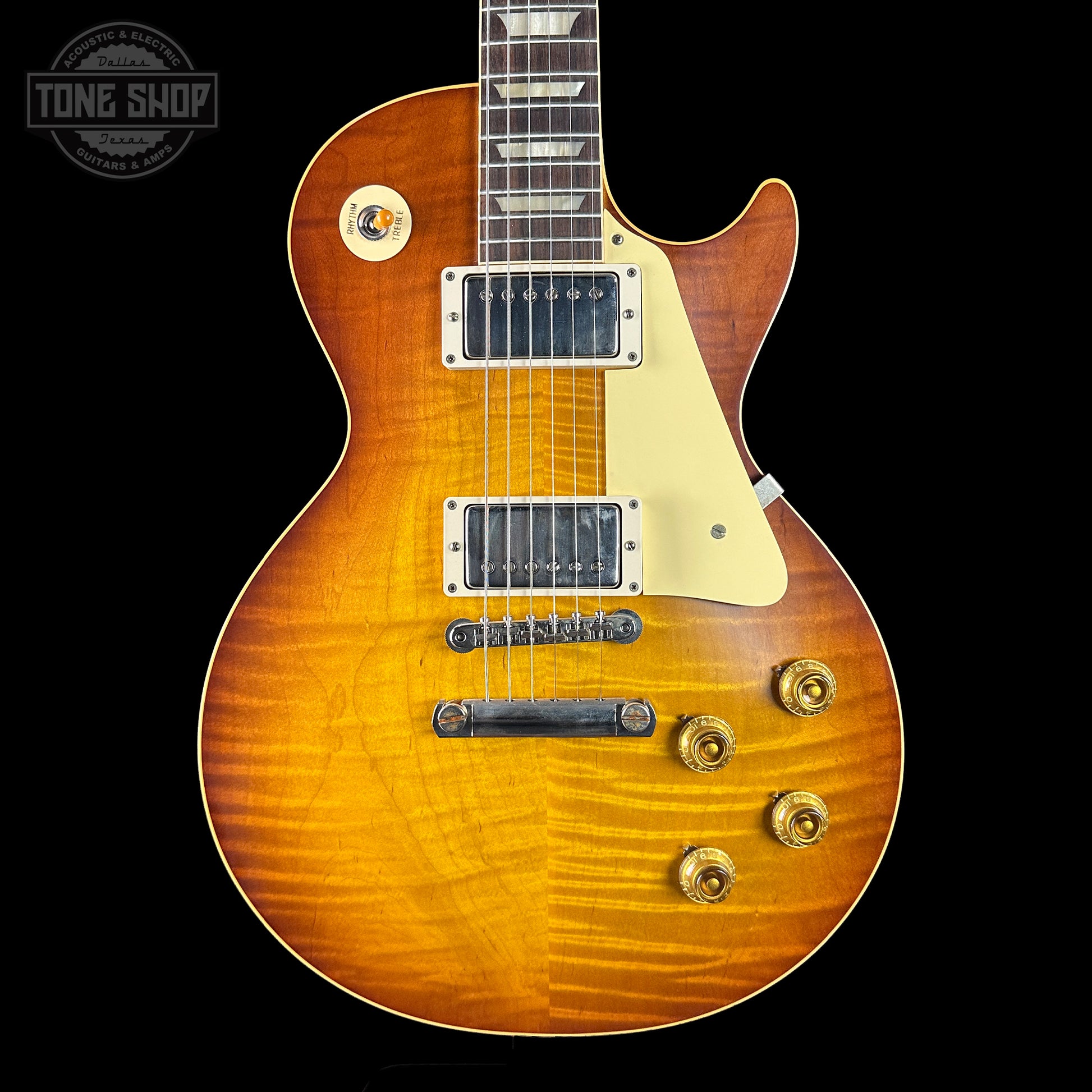 Gibson Les Paul electric guitar with a sunburst finish on a black background, featuring the Tone Shop logo.