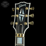 Gibson guitar headstock with brand logo on a black background