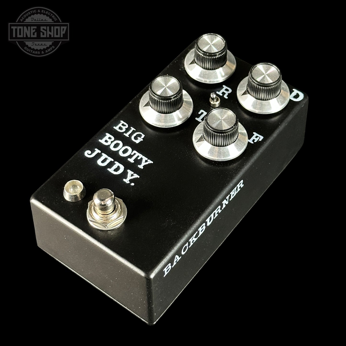 Guitar effects pedal with 'Big Booty Judy' and 'Backburner' branding on a black background.