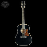 Acoustic guitar with a black finish on a white background