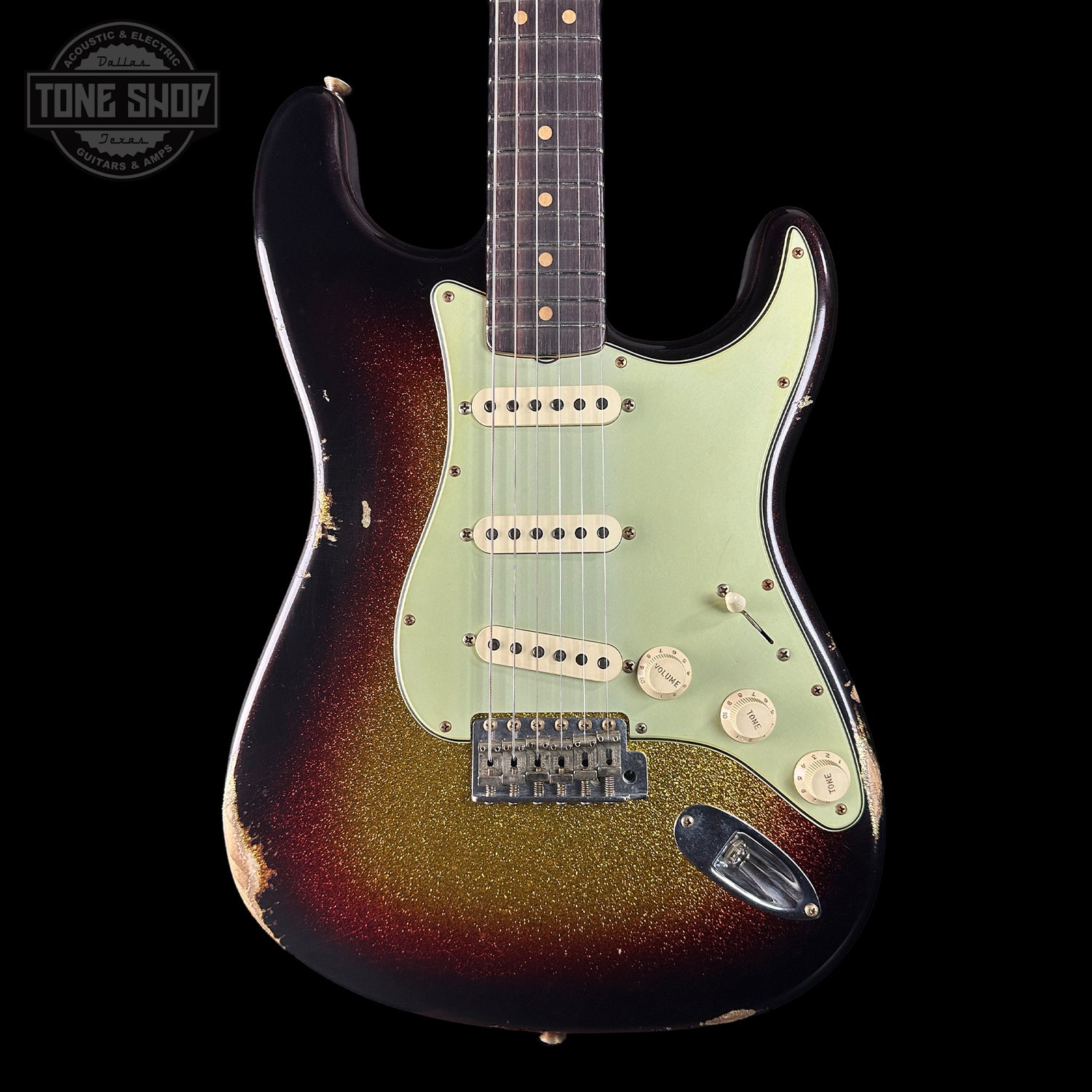 Fender Stratocaster guitar with sunburst finish on a black background, featuring 'Tone Shop' branding.