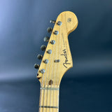 Fender guitar headstock on a blue background
