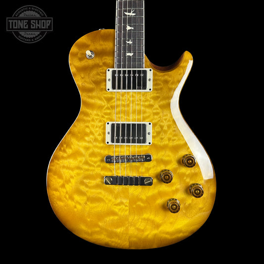 Yellow electric guitar with a black background
