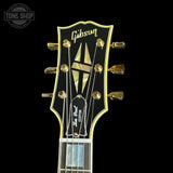 Gibson Les Paul Custom guitar headstock on a black background