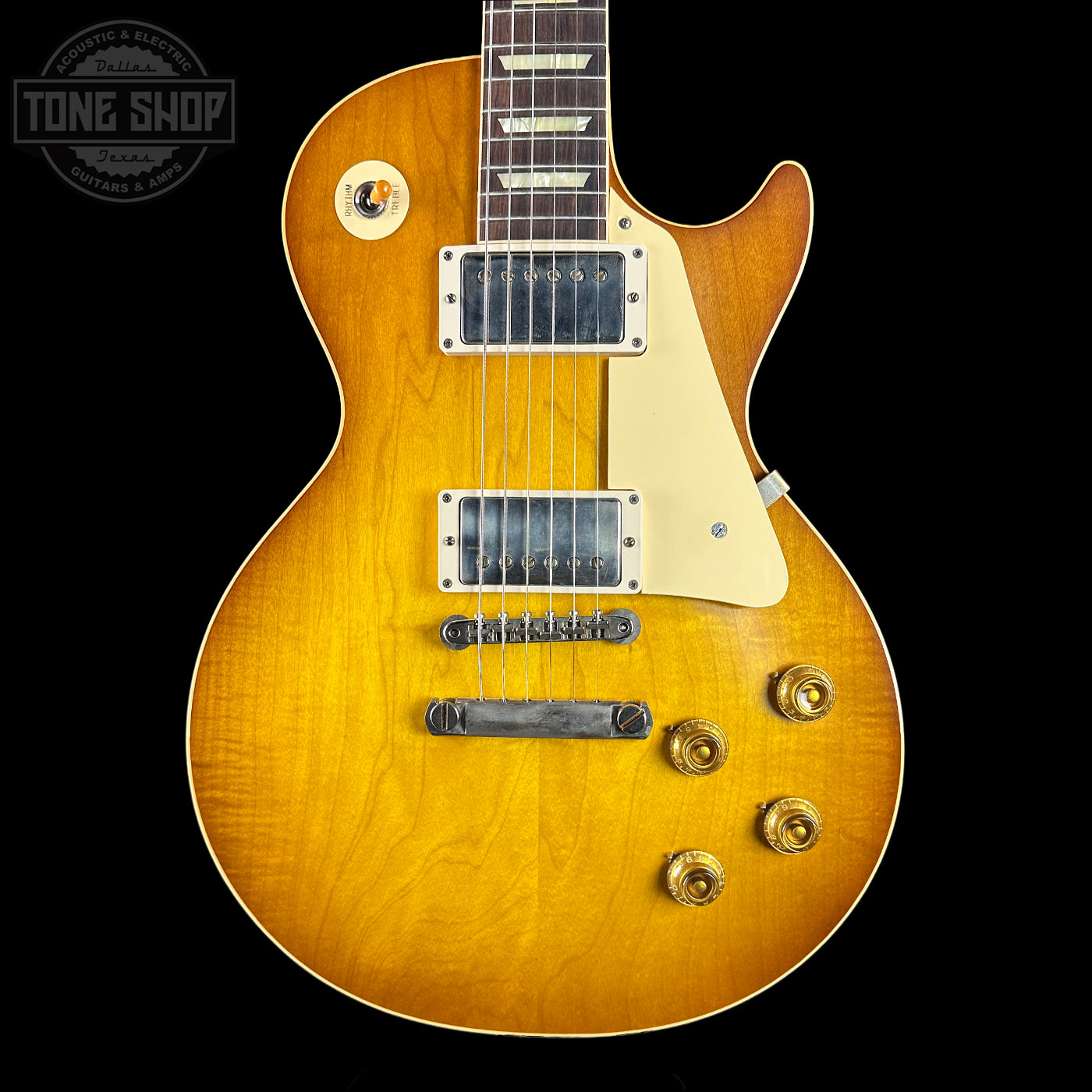 Electric guitar with a sunburst finish on a black background, featuring the Tone Shop logo.