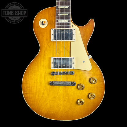 Electric guitar with a sunburst finish on a black background, featuring the Tone Shop logo.