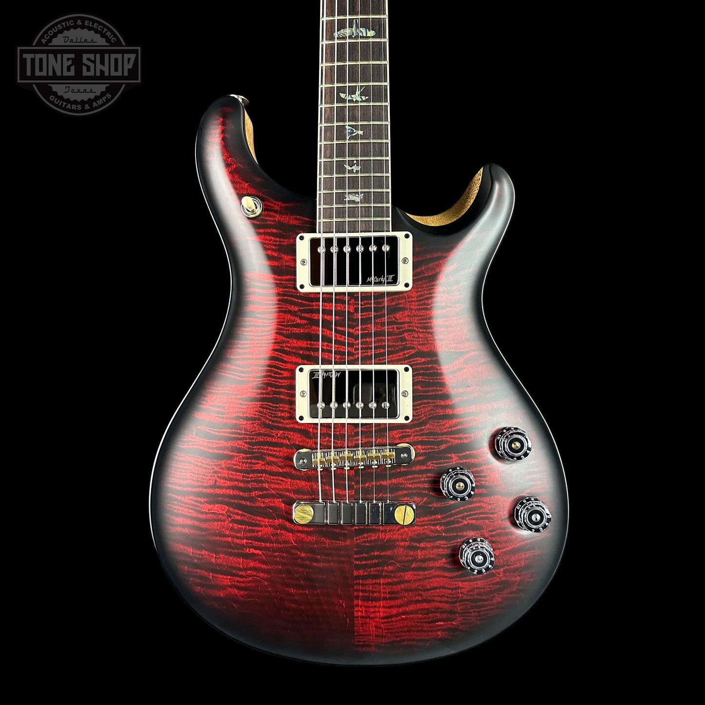 Red electric guitar with black background. 