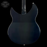 The rear view of an electric guitar body, featuring a glossy black finish and a contoured cutaway shape, shown against a solid black background with a Tone Shop watermark in the top-left corner.