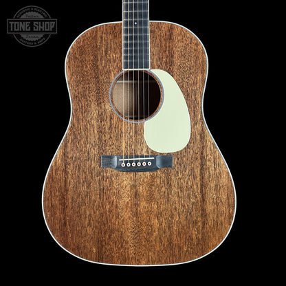 Acoustic guitar with a wooden finish on a black background, featuring the Tone Shop logo.