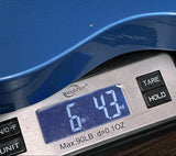 A blue electric guitar body resting on a digital scale showing 6.43 lbs, with a close-up of the scale and part of the guitar visible.
