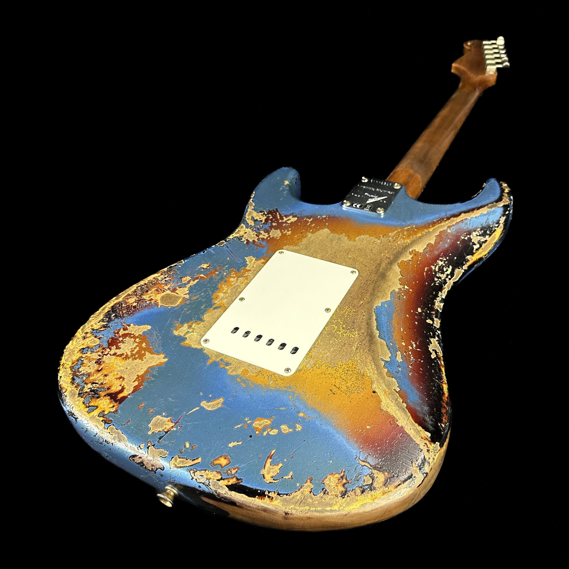 Back angle of Fender Custom Shop Limited Edition Roasted '60 Strat Super Heavy Relic Aged Lake Placid Blue Over 3 Color Sunburst.