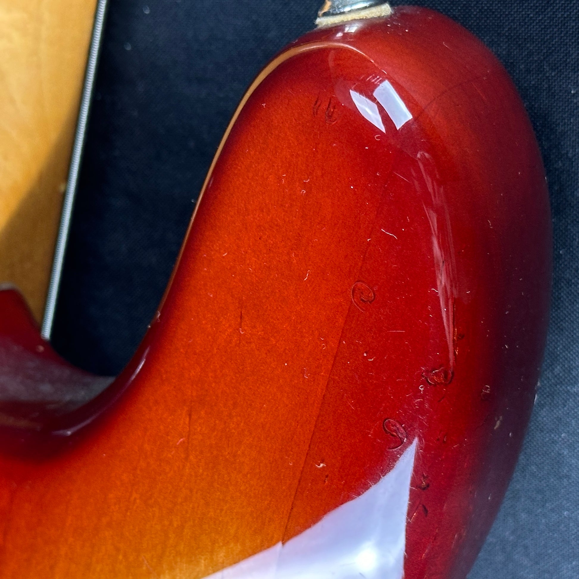 Damage on upper horn of Used 1983 Fender Elite Precision Bass II Sienna Burst.