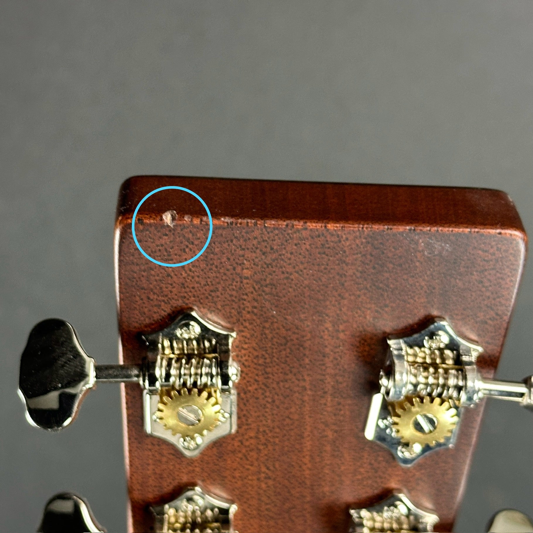 Ding on headstock of Used Martin D-28 Ambertone.