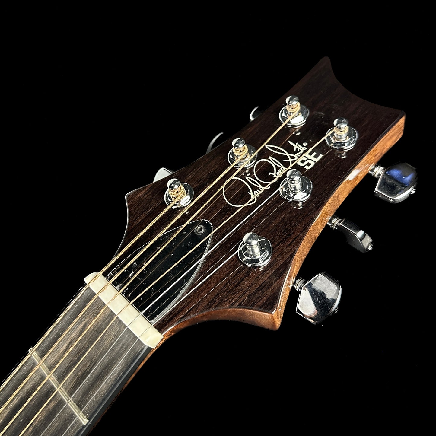 Front of headstock of Used PRS SE Angelus A50E Fire Red Burst.